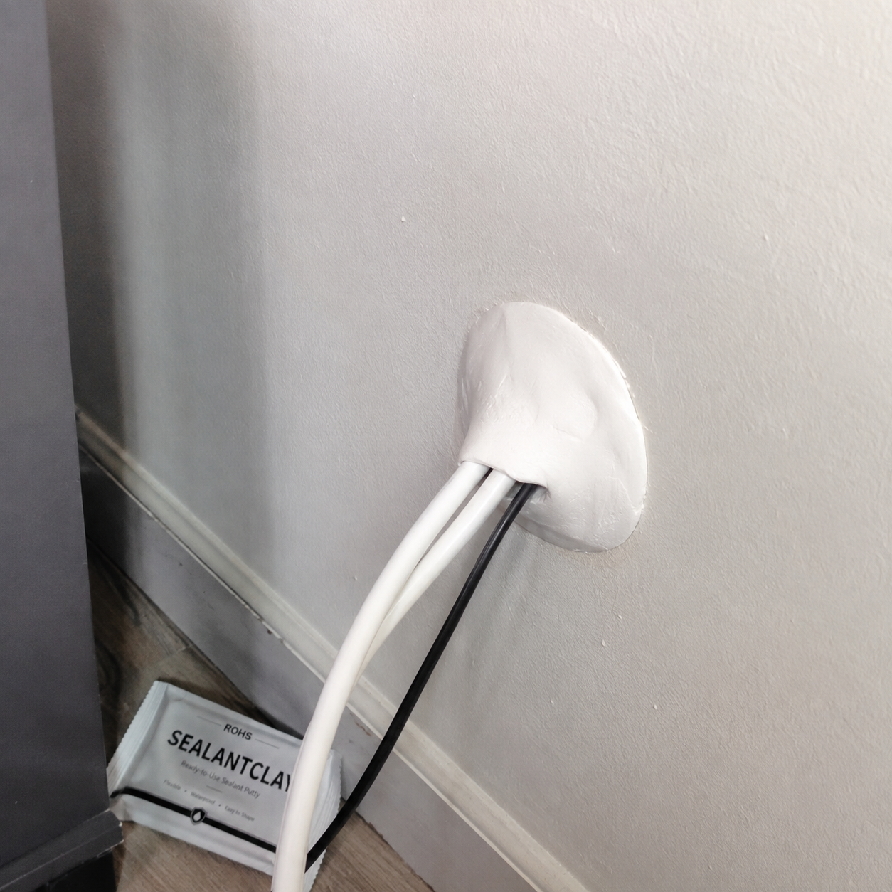 Customer cable opening sealed with sealing clay